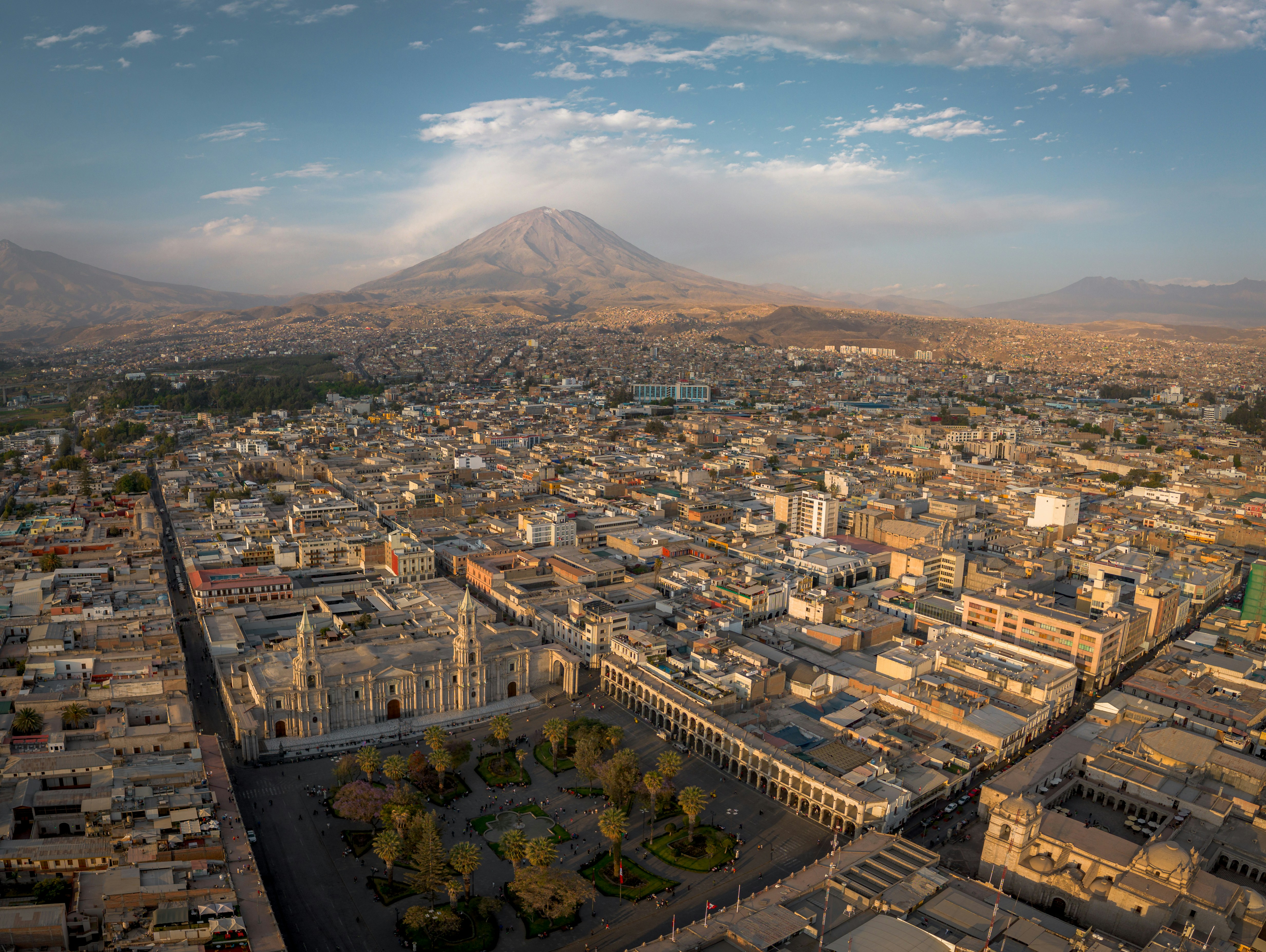 a panaromic shot of the city of arequipa the basilica cathedral in the city square and the misti volcano are seen